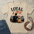 Beige crewneck t-shirt featuring a graphic of a man and his dog overlooking mountains with the text Loyal For Life.