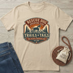 Beige crewneck t-shirt featuring a vintage-style Rescue Dog Adventure Club graphic with a dog, mountains, and trees.