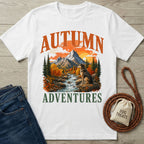 White crewneck t-shirt featuring a mountain, river, and dog graphic with Autumn Adventures text.