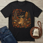 Black crewneck t-shirt featuring a Golden Retriever walking on a leaf-covered forest trail with mountains in the background.