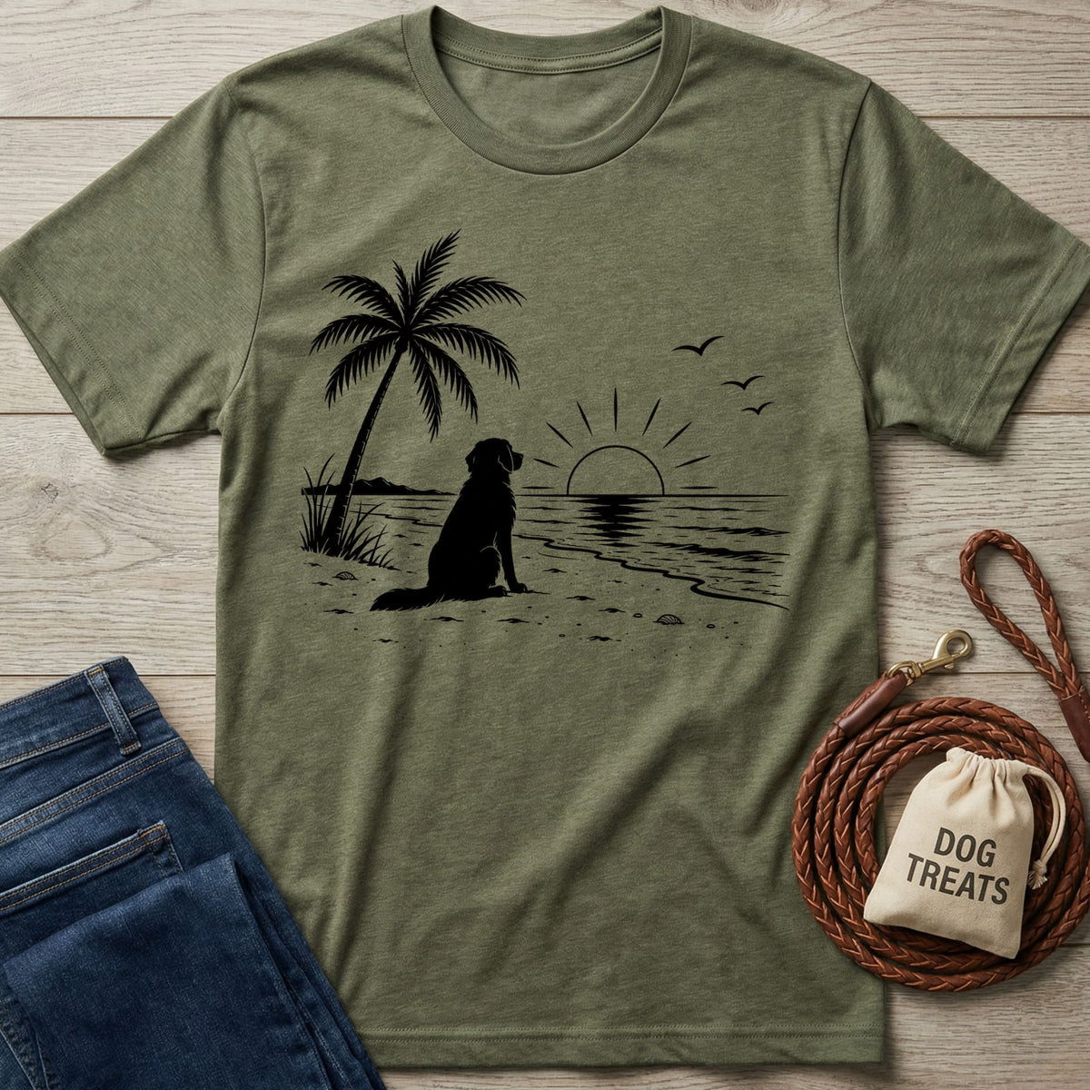 Olive green crewneck t-shirt featuring a black graphic of a dog sitting on a beach under a palm tree at sunset.