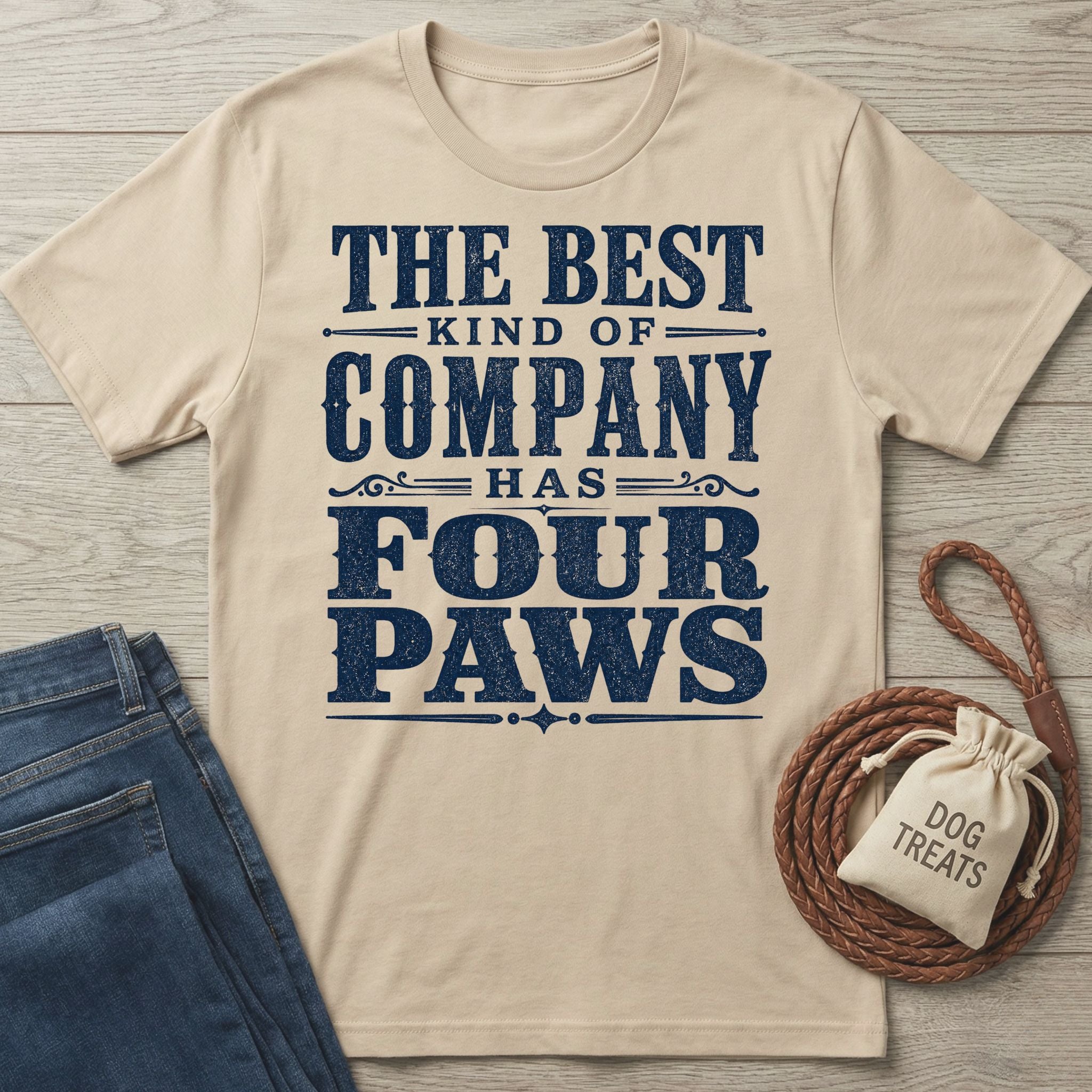 Beige vintage-style crewneck t-shirt with navy blue text reading The Best Kind Of Company Has Four Paws.