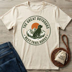 Cream-colored crew neck t-shirt featuring a vintage mountain and dog graphic with the text The Great Outdoors Best Trail Buddy.