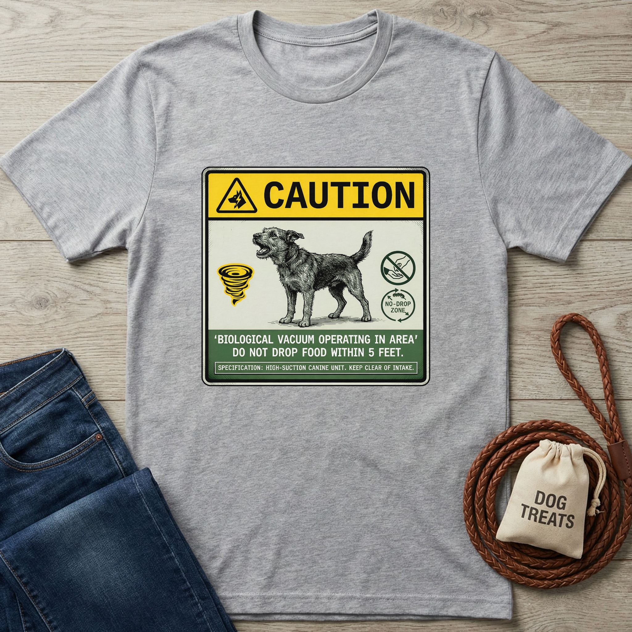 Light grey Gildan Softstyle® t-shirt with a "Biological Vacuum" dog graphic, beside jeans and dog treats.