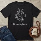 Black Gildan Softstyle® t-shirt with a white line art dog head and "blooming heart" text.