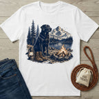 White crewneck t-shirt featuring a black Labrador, campfire, lantern, and mountain lake graphic print.