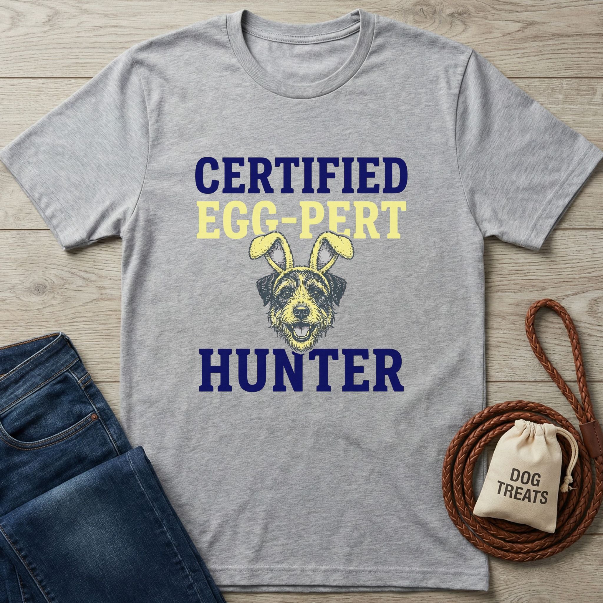 Light grey Gildan Softstyle t-shirt with "Certified Egg-Pert Hunter" text and a dog in bunny ears.