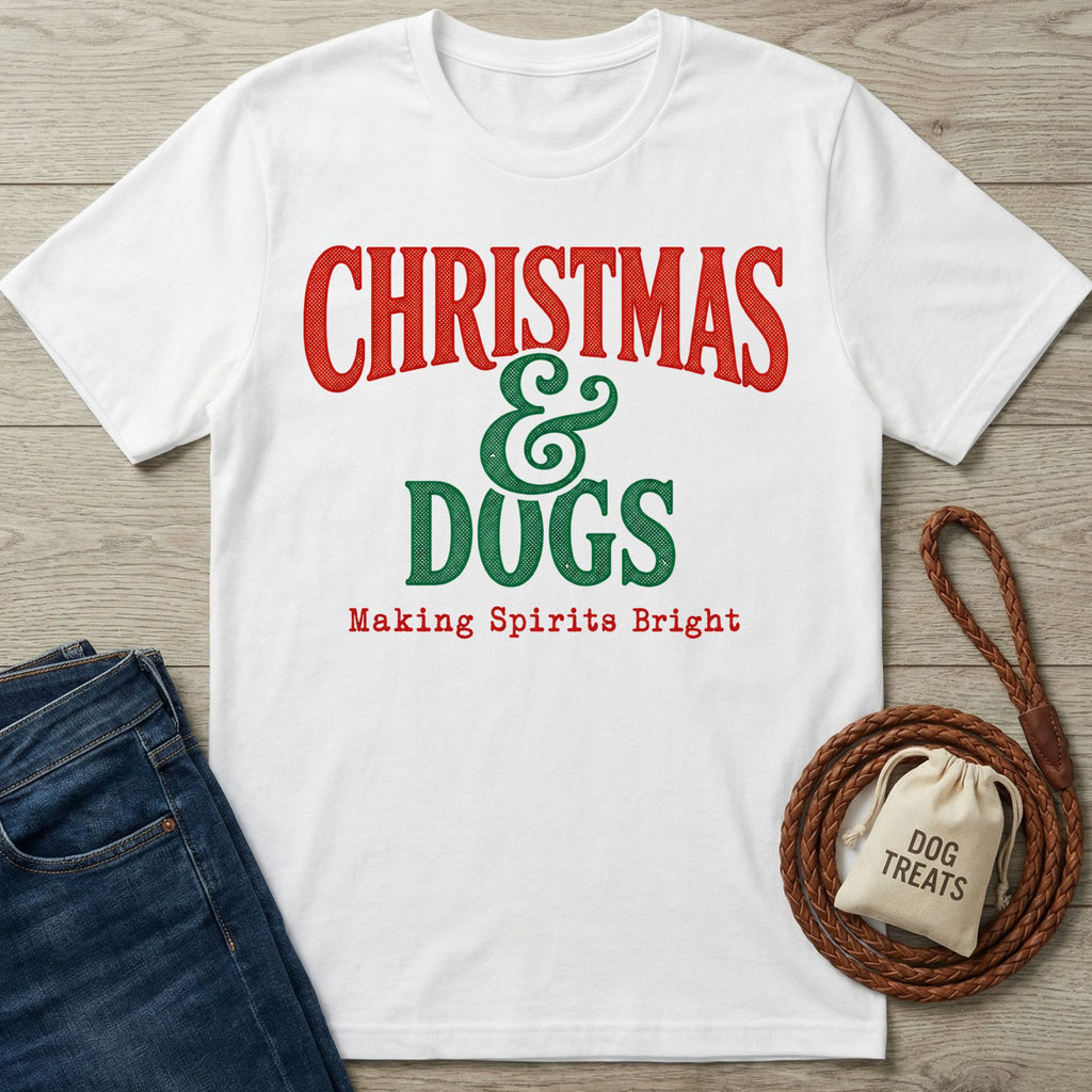 White cotton T-shirt with vintage-style red and green Christmas and Dogs graphic text on a wooden background.