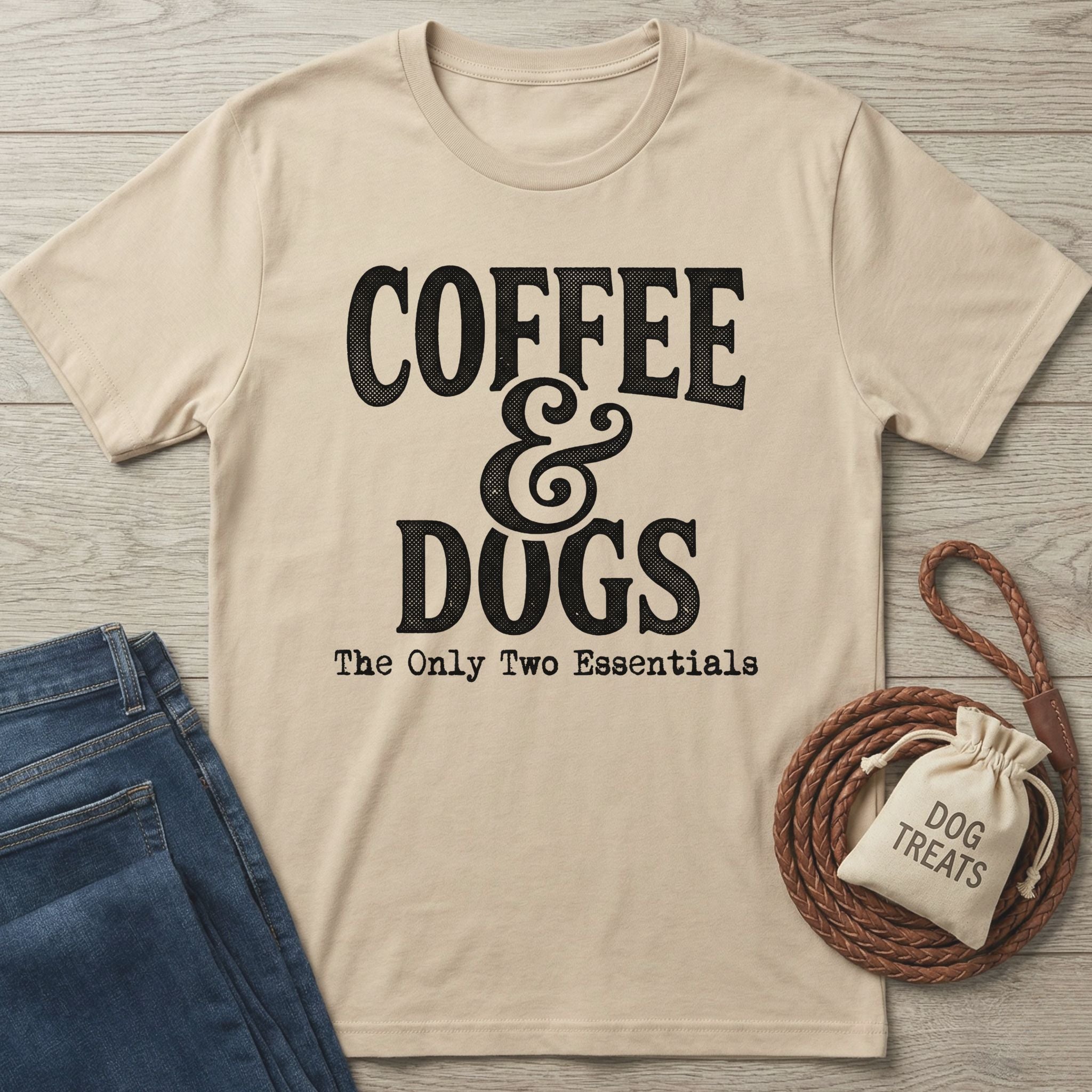 Sand-colored "Coffee & Dogs" graphic tee with jeans, a braided leash, and a "Dog Treats" bag.