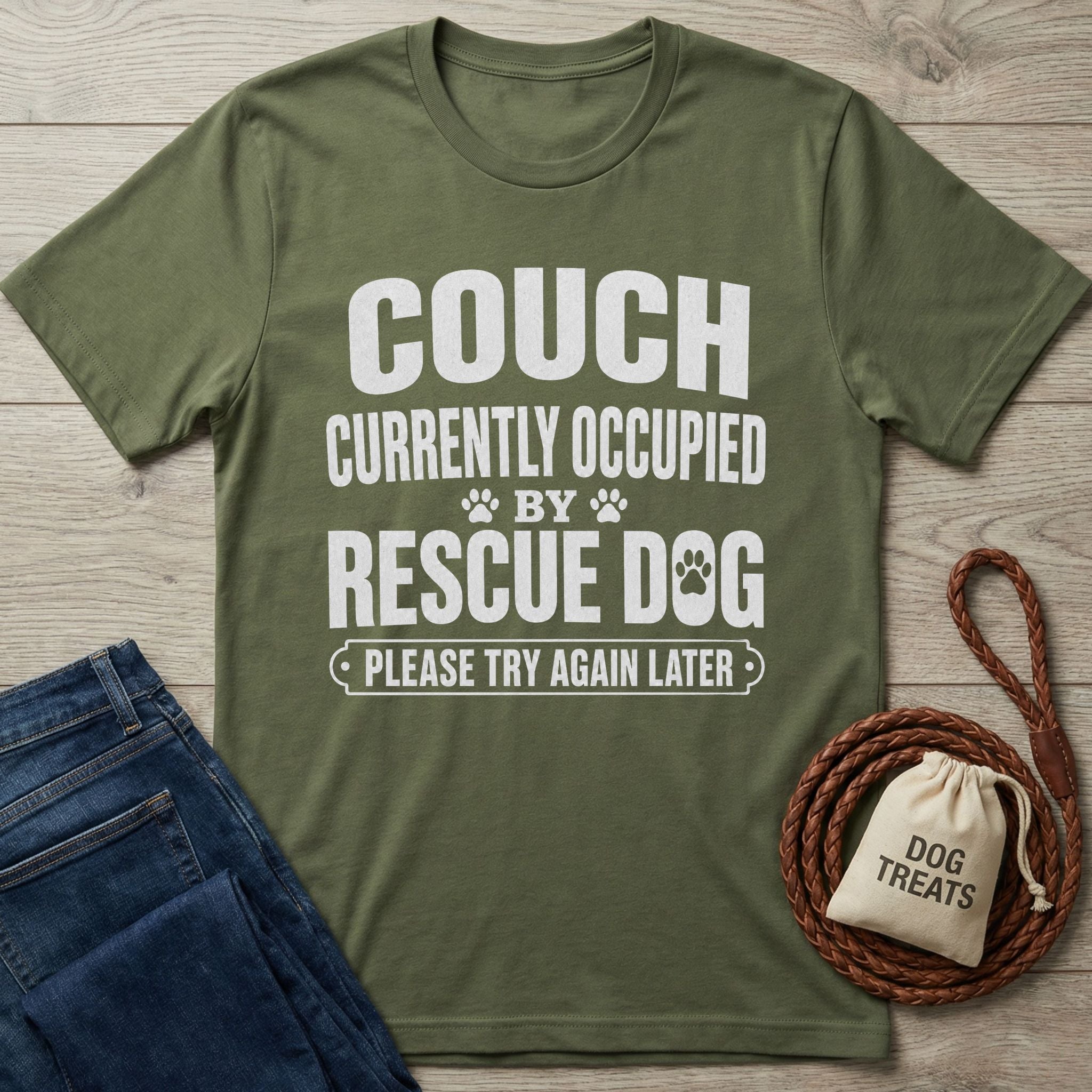 Olive green Gildan Softstyle t-shirt with "THE COUCH IS CURRENTLY OCCUPIED BY A RESCUE DOG AND HIS HUMAN PLEASE TRY AGAIN LATER" text.