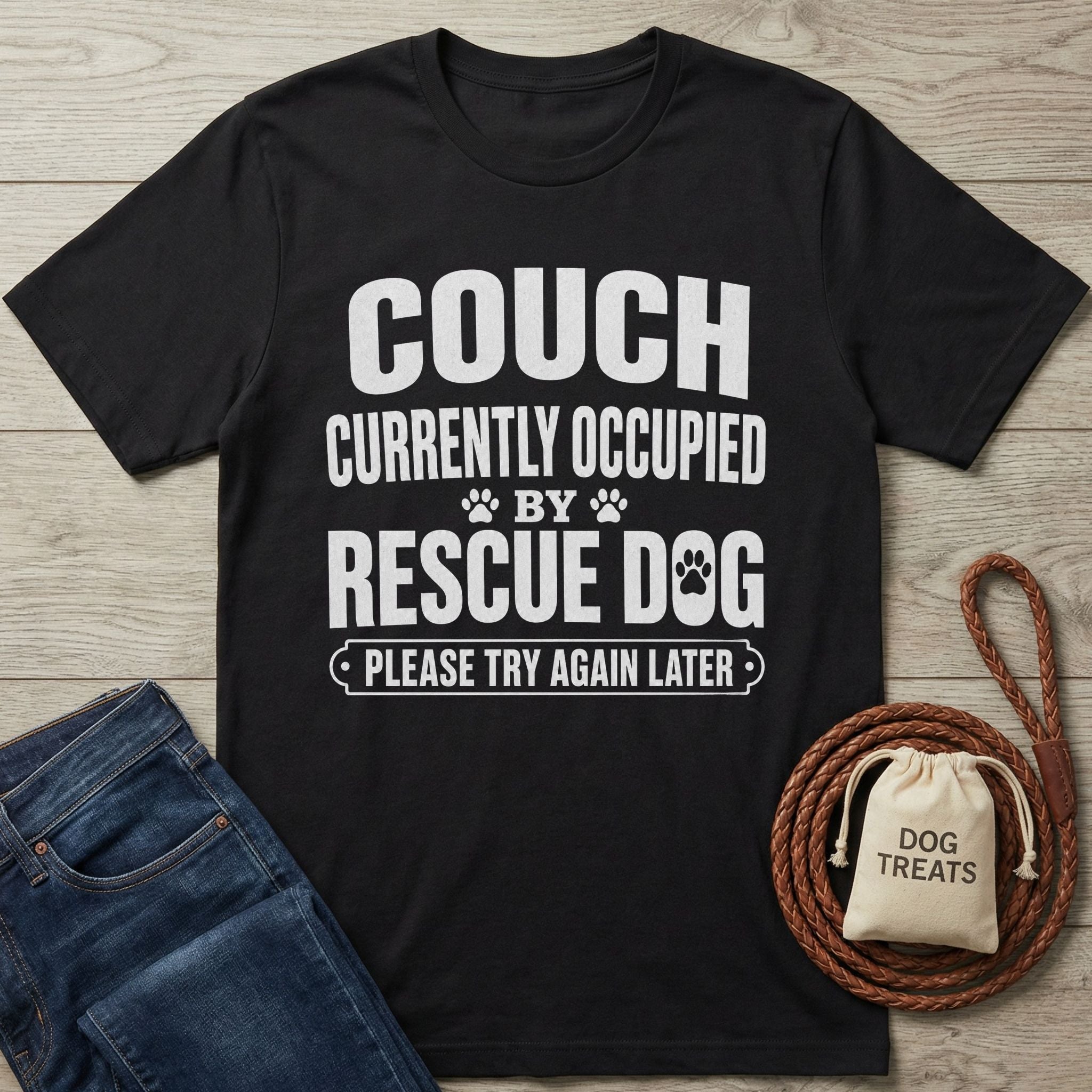 Black Gildan Softstyle® 64000 tee with "THE COUCH IS CURRENTLY OCCUPIED BY A RESCUE DOG AND HIS HUMAN PLEASE TRY AGAIN LATER" text.