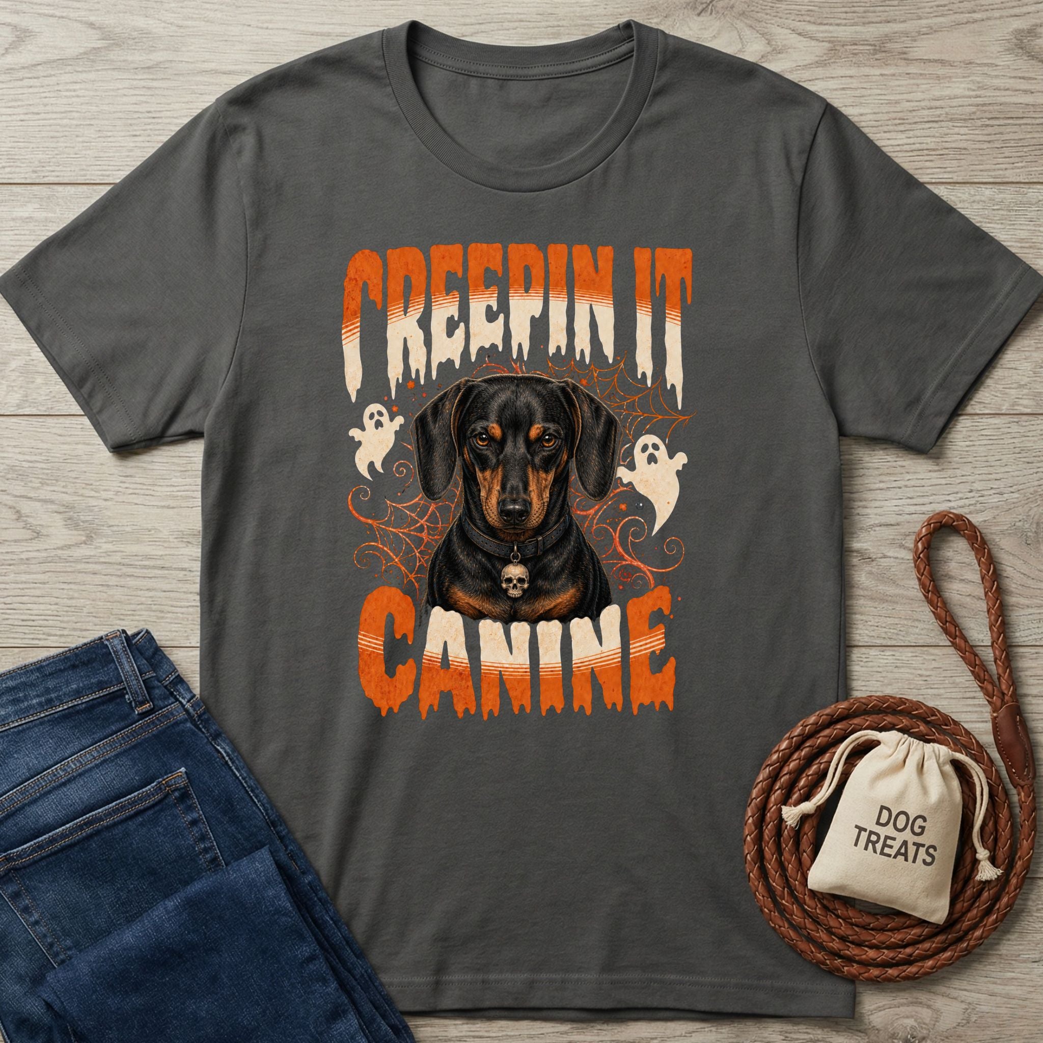 Dark gray crewneck t-shirt featuring a Dachshund with a skull collar, ghost graphics, and Creepin It Canine text.