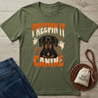 Olive green t-shirt featuring a Dachshund graphic with ghosts, spiderwebs, and Creepin It Canine text in orange and white.