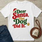 White crewneck t-shirt with festive red, green, and gold Dear Santa The Dog Did It text and a Santa hat graphic.