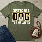 Olive green crewneck t-shirt featuring Official Dog Translator text and a dog nose graphic, displayed with jeans and a treat bag.