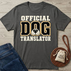 Charcoal gray cotton t-shirt with Official Dog Translator text and a dog nose graphic, displayed with jeans and a treat bag.