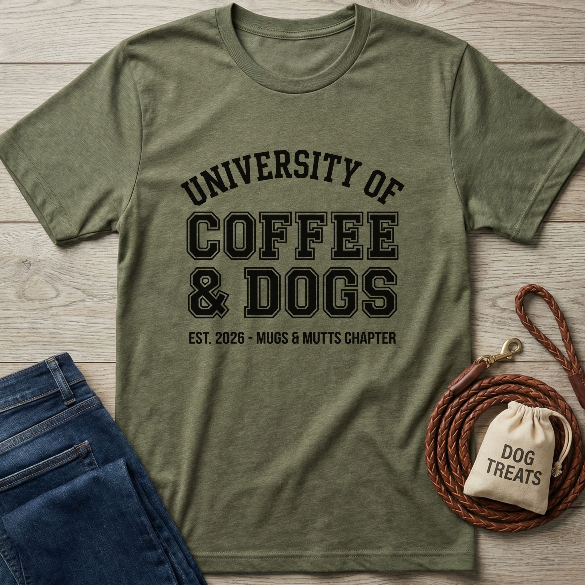 Olive green "University of Coffee & Dogs" t-shirt with black text, next to jeans and dog treats.