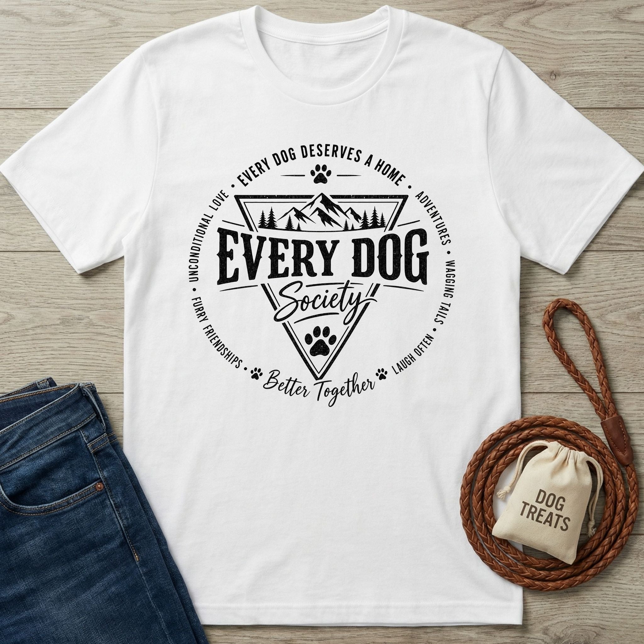 White cotton t-shirt featuring a black Every Dog Society badge graphic with mountain and paw print illustrations.