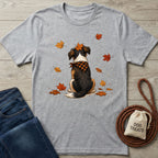 Grey crewneck t-shirt featuring a dog in a plaid bandana sitting among falling autumn leaves.