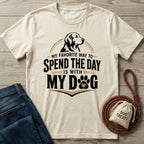 Cream-colored cotton t-shirt featuring a dog illustration and the text My Favorite Way To Spend The Day Is With My Dog.
