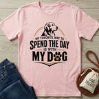 Light pink crewneck T-shirt featuring a black dog graphic and the text My Favorite Way To Spend The Day Is With My Dog.