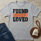 Light grey Gildan Softstyle t-shirt with "FOUND CHOSEN LOVED" text, paired with jeans and dog treats.