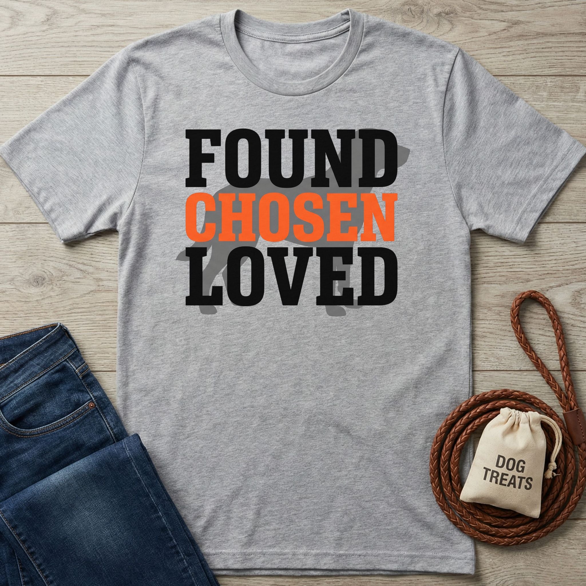 Light grey Gildan Softstyle t-shirt with "FOUND CHOSEN LOVED" text, paired with jeans and dog treats.