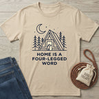 Tan Gildan Softstyle t-shirt with "Home is a Four-Legged Word" graphic, dog, cabin, and trees.