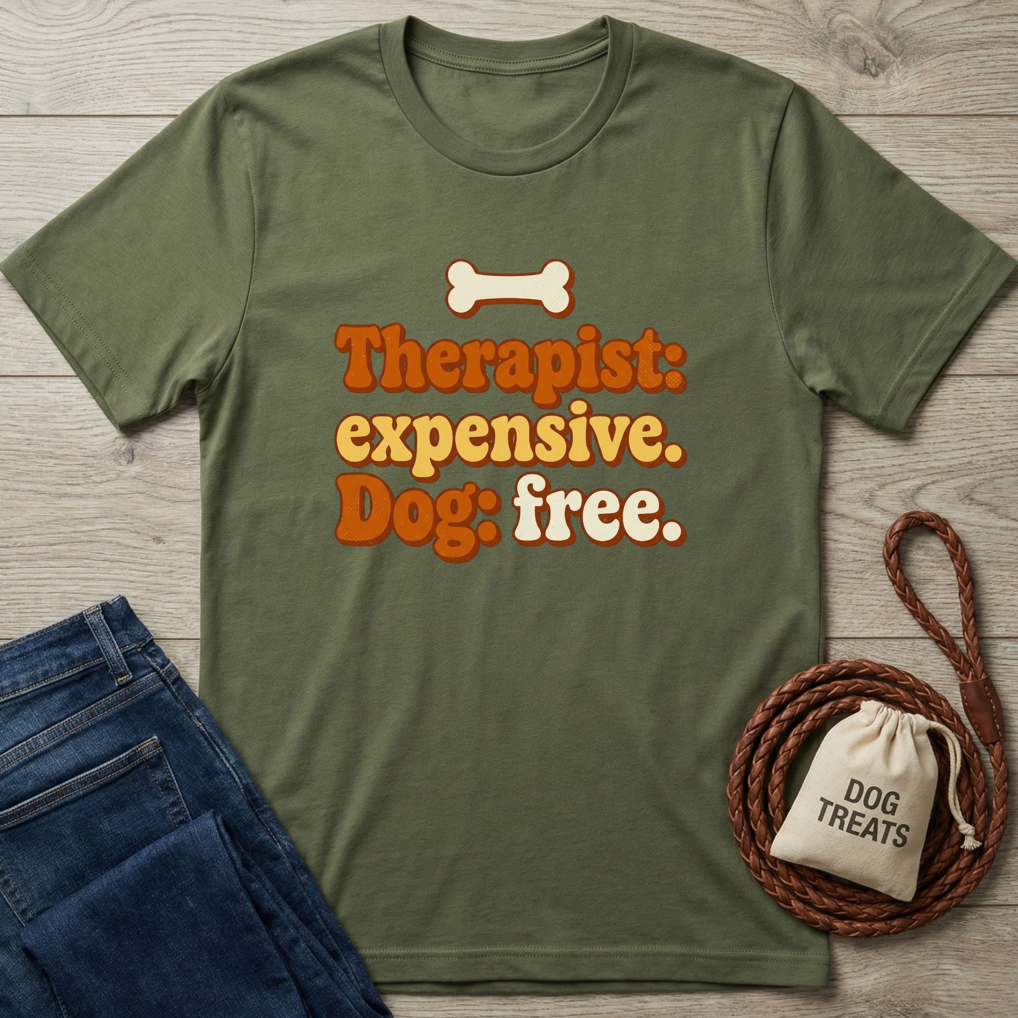 Olive green Gildan Softstyle t-shirt with "Therapist: expensive. Dog: free." text and a bone graphic.