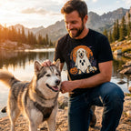 Man wearing a black t-shirt with a Golden Retriever in a ghost costume, harvest moon, and haunted house graphic design.