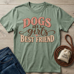 Sage green crewneck t-shirt with retro Dogs Are A Girl's Best Friend graphic text, laid flat with jeans and a dog leash.