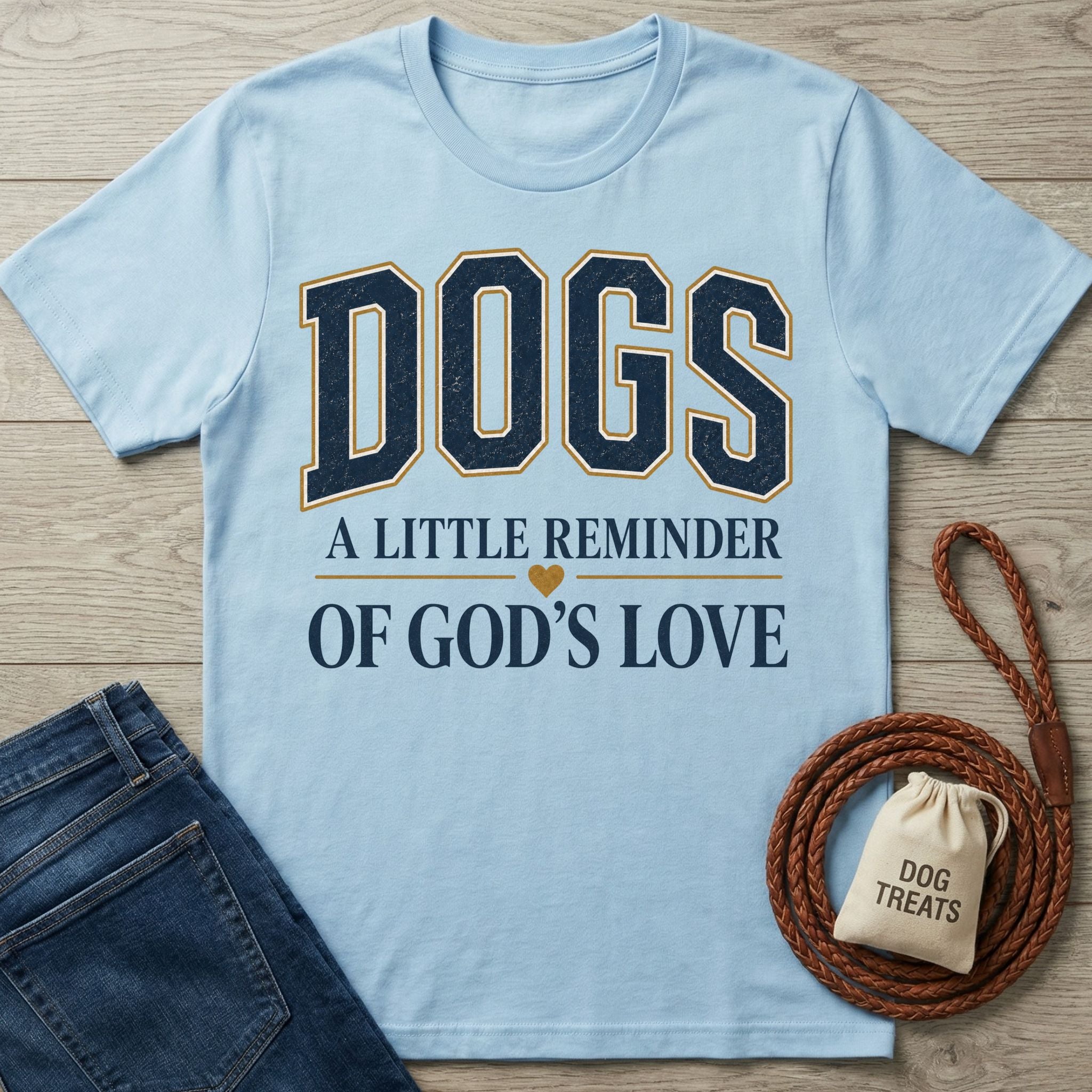 Light blue crewneck t-shirt featuring the text Dogs: A Little Reminder of God's Love with a small heart icon.