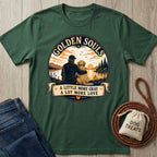 Dark green Golden Souls T-shirt with a graphic of a person and dog watching a sunset over a lake.