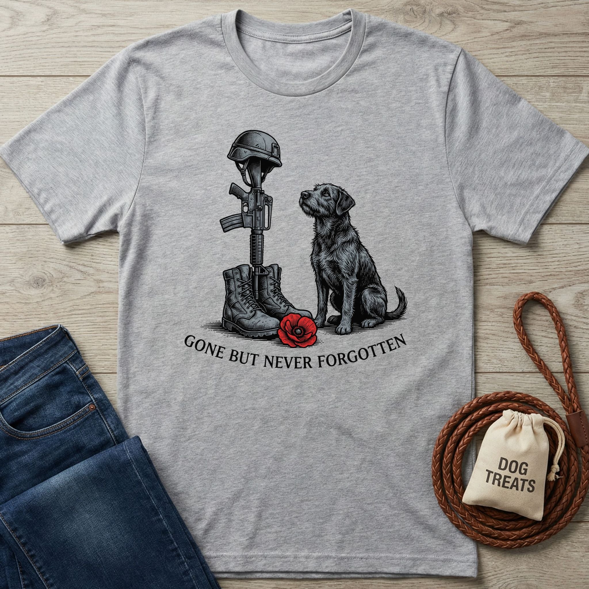 Light grey Gildan Softstyle® t-shirt with a "Gone But Never Forgotten" graphic featuring a black dog, soldier's boots, rifle, helmet, and a red poppy.
