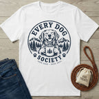 White cotton t-shirt featuring a navy graphic of a smiling dog holding a coffee mug with mountain and forest scenery.