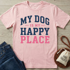 Light pink crew neck t-shirt featuring the navy and pink distressed text My Dog Is My Happy Place on a wooden surface.