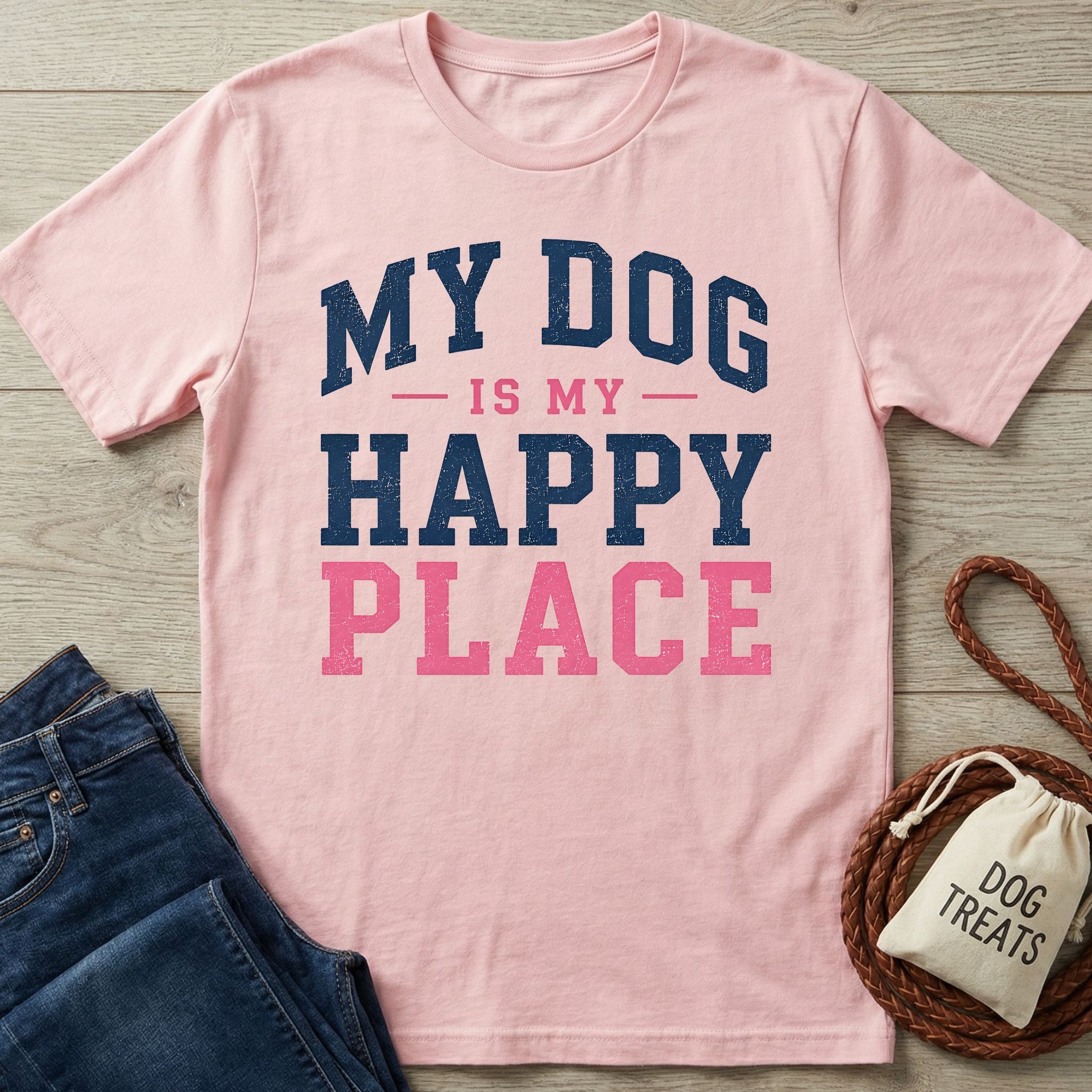 Light pink crew neck t-shirt featuring the navy and pink distressed text My Dog Is My Happy Place on a wooden surface.