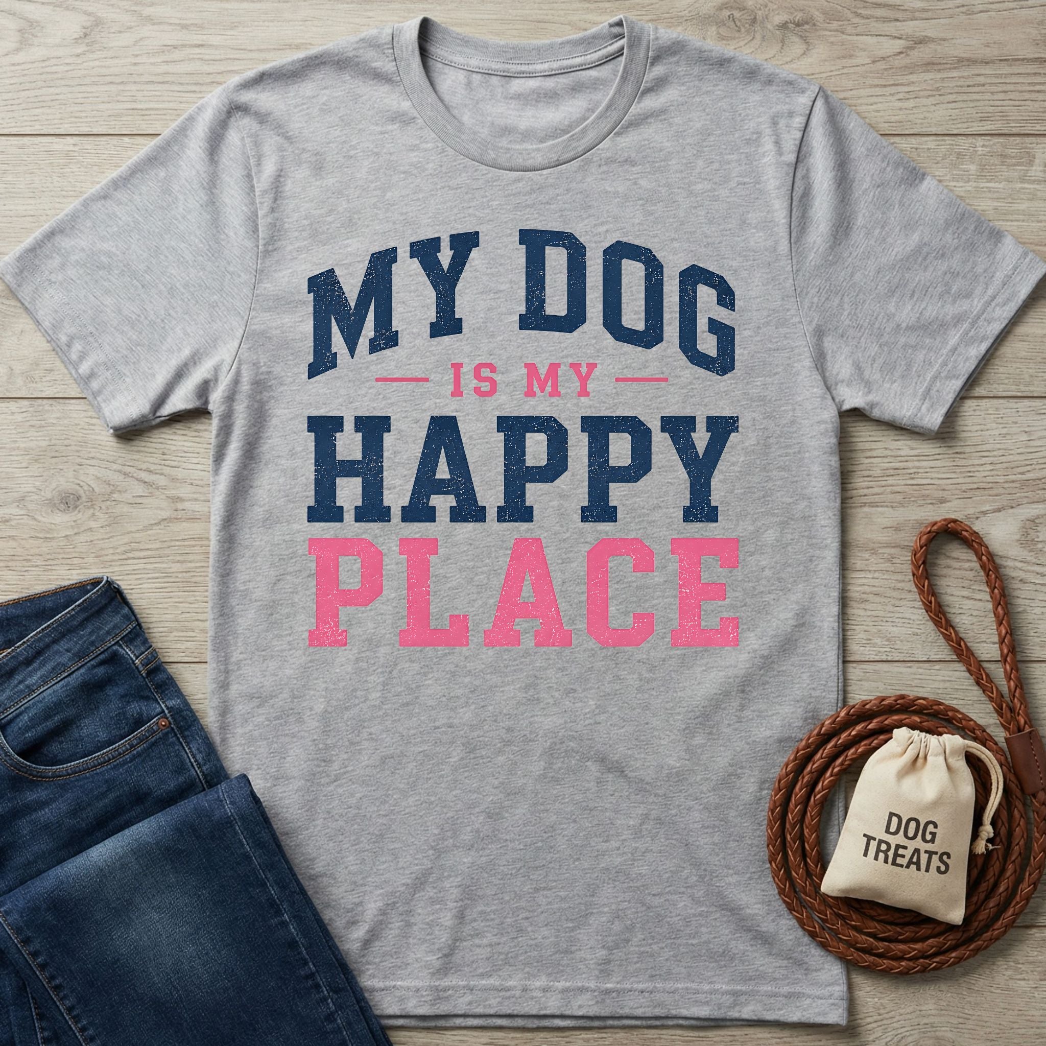 Grey crewneck t-shirt with navy and pink distressed text reading My Dog Is My Happy Place on a wooden background.