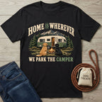 Black cotton t-shirt featuring a vintage camper, campfire, and two dogs with the text Home Is Wherever We Park The Camper.