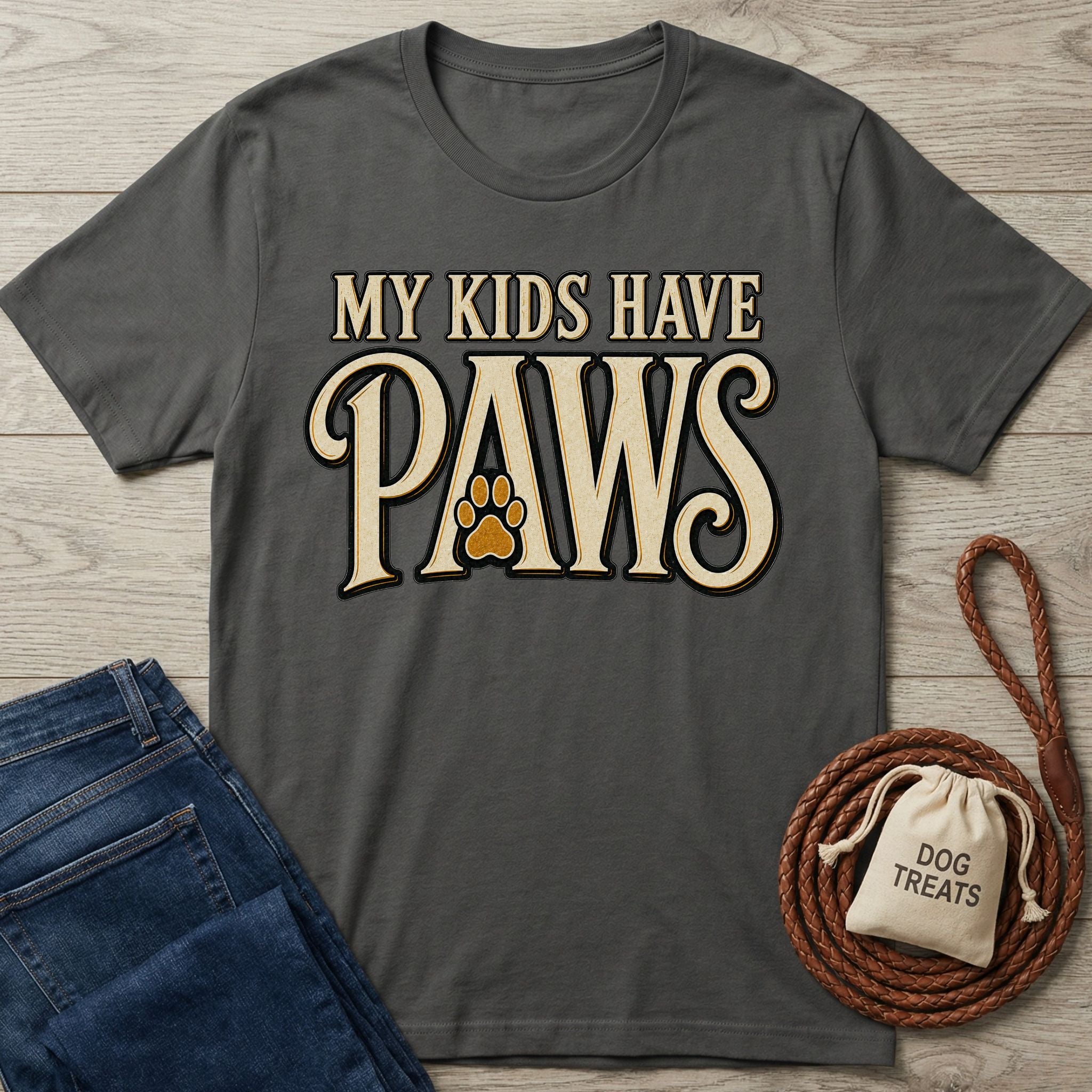 Charcoal gray crewneck t-shirt featuring the text My Kids Have Paws with a paw print graphic on a wooden background.