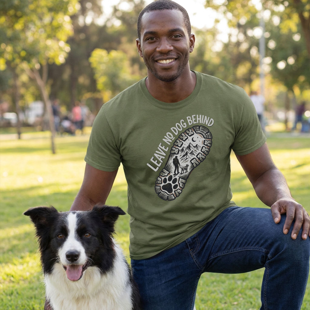 Man in olive green "Leave No Dog Behind" tee with a paw print boot graphic, kneeling beside a Border Collie.