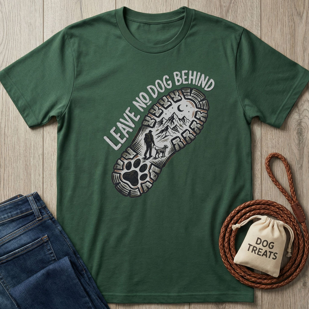 Forest green Gildan Softstyle® t-shirt with "Leave No Dog Behind" and a paw print boot sole graphic.