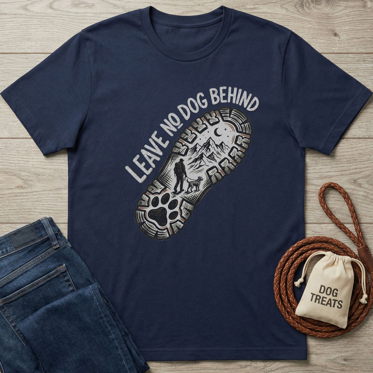 Navy Gildan Softstyle® t-shirt with "Leave No Dog Behind" and a hiking boot print featuring a person and dog.