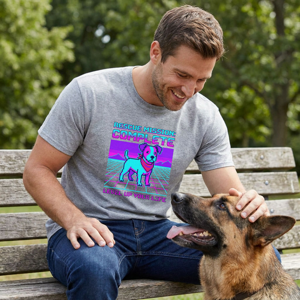 Man in a grey Gildan Softstyle® tee with a pixel art rescue dog graphic, petting a German Shepherd.