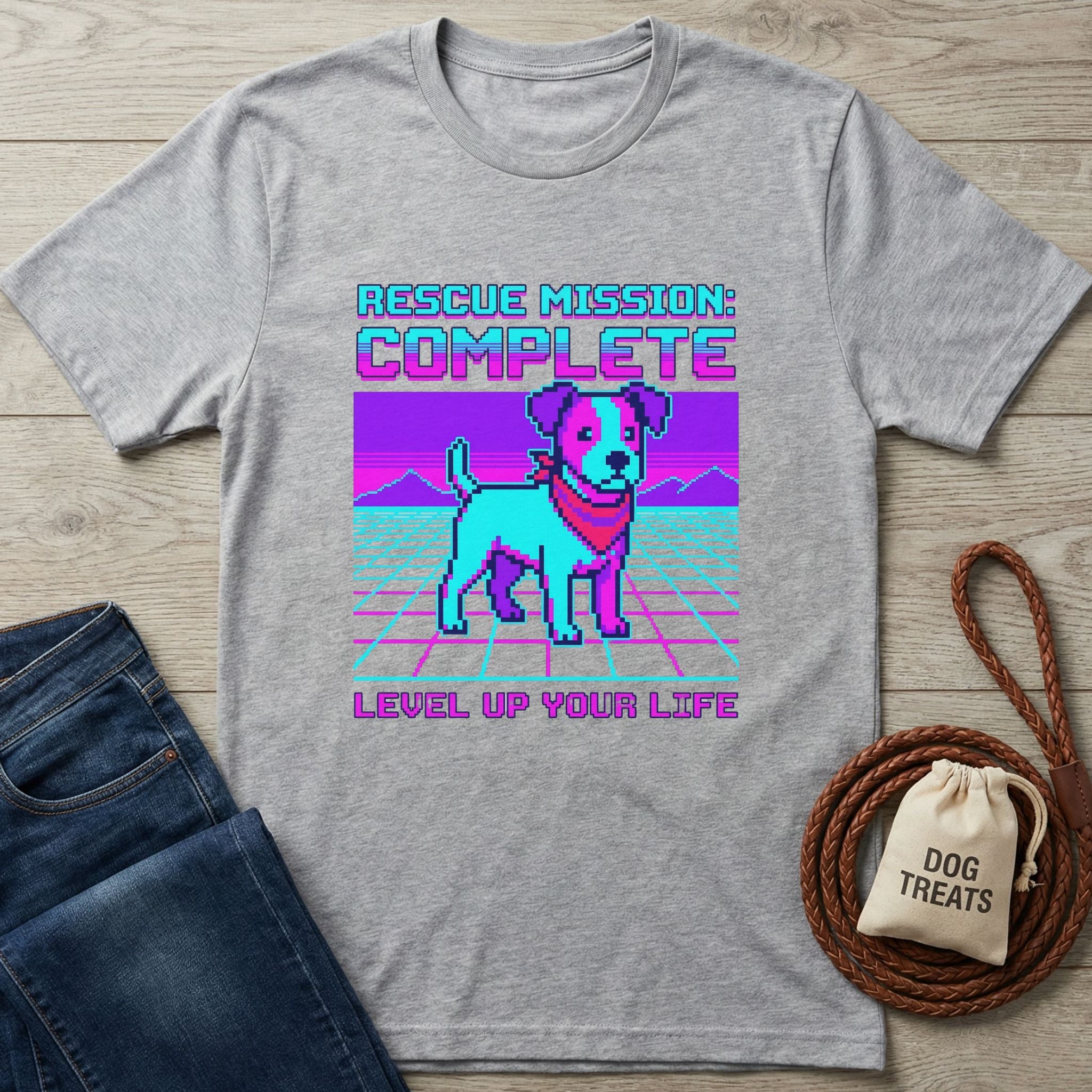 Light grey Gildan Softstyle t-shirt with a retro pixel art dog and "Rescue Mission: Complete, Level Up Your Life" text.