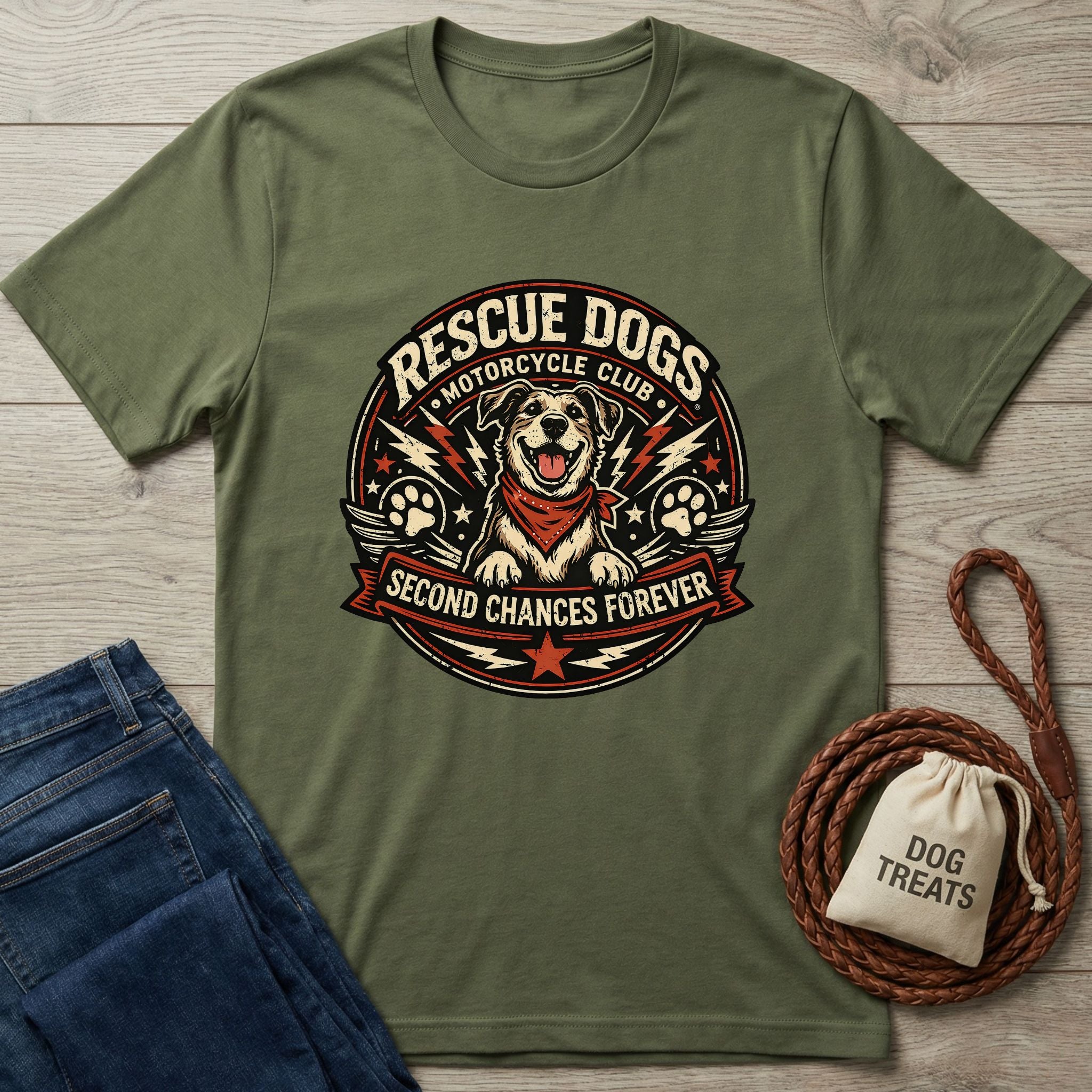 Olive green "Rescue Dogs Motorcycle Club" tee with a happy dog graphic, next to jeans and dog treats.