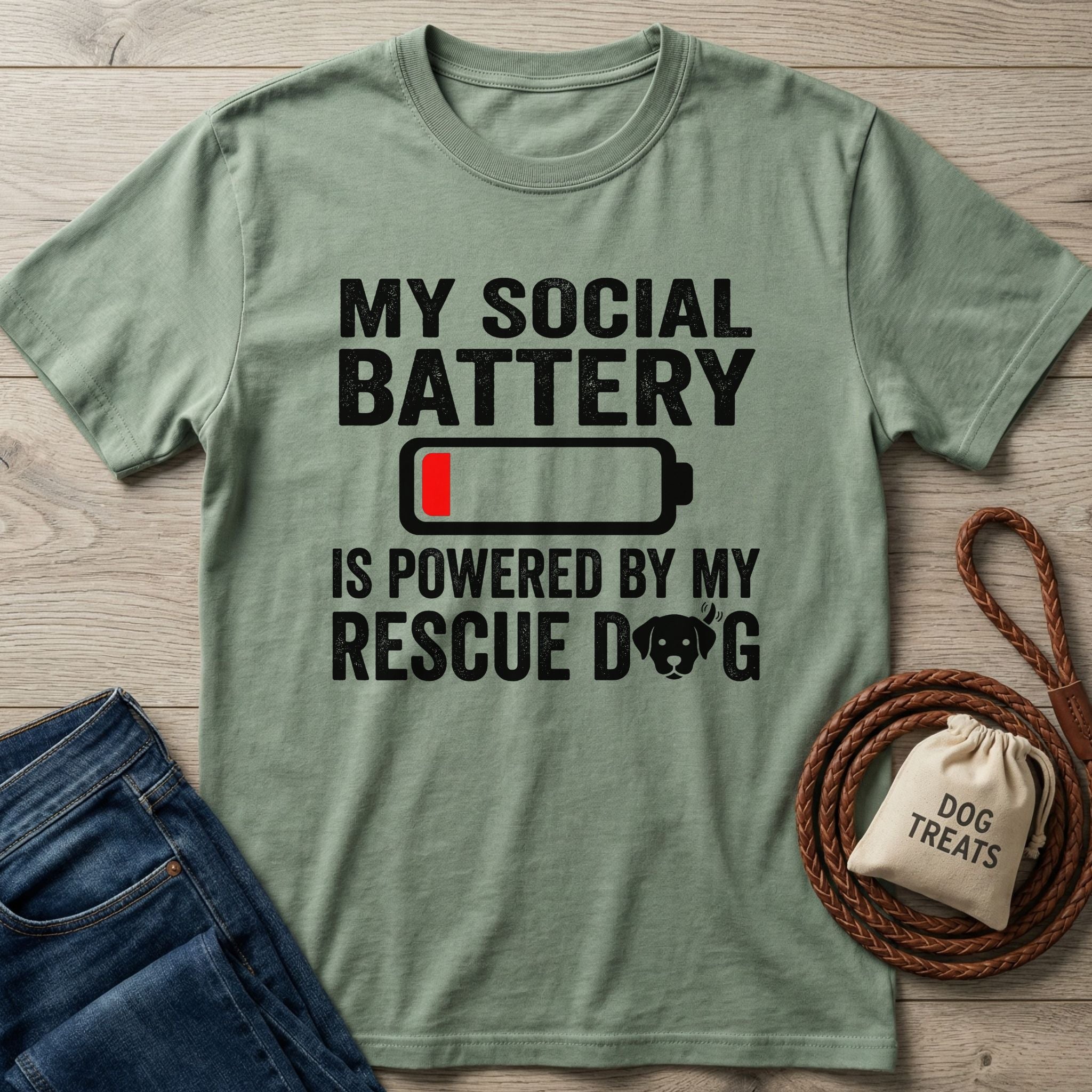 Sage green Gildan Softstyle® t-shirt with "My Social Battery Is Powered By My Rescue Dog" text and battery icon.