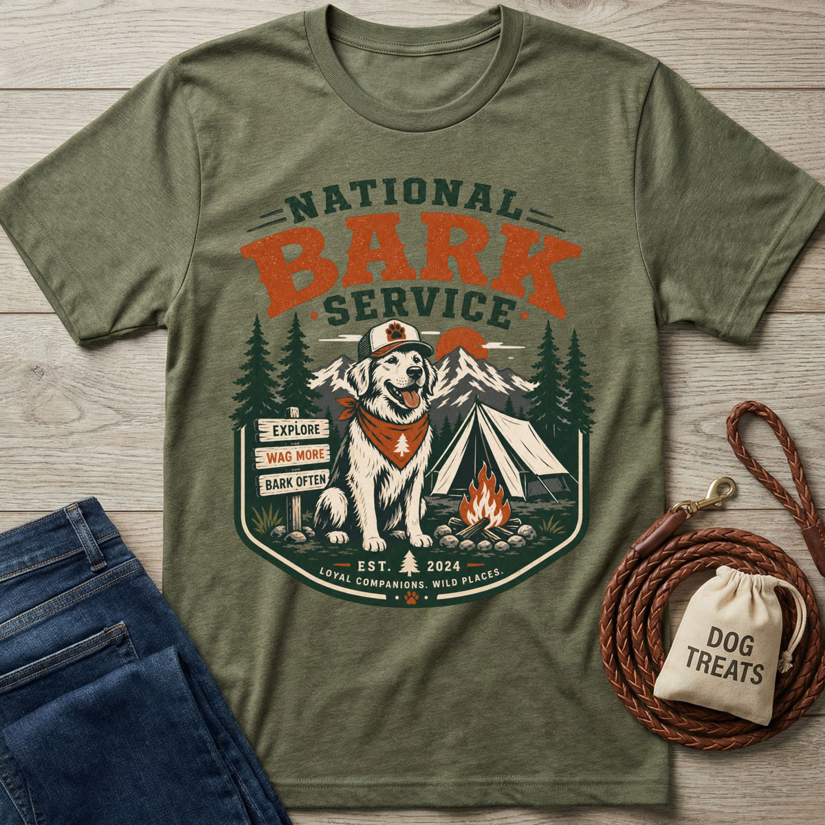 Olive green crewneck t-shirt featuring a National Bark Service graphic with a dog, camping gear, and mountains.