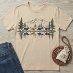 Beige crewneck t-shirt featuring a mountain landscape illustration with dogs walking along a reflective lake shore.
