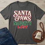 Charcoal gray crewneck T-shirt with Santa Paws Naughty List text in festive red, white, and green on a wooden background.